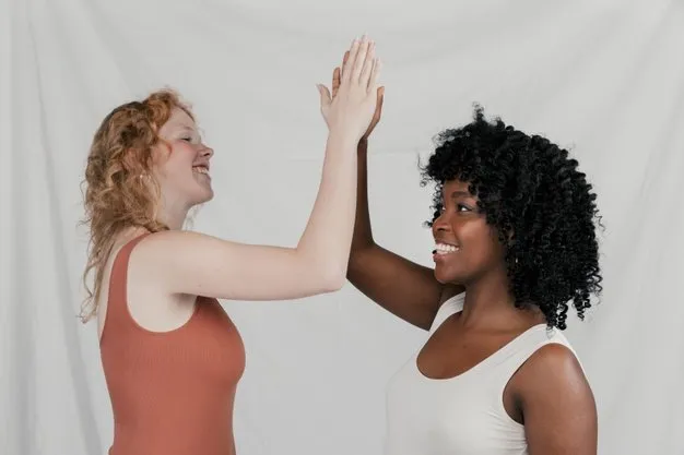 blonde-african-young-women-giving-high-five-against-grey-background_23-2148178786-712w